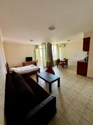 a living room with a couch and a table at Sea View Apartment Sveti Vlas in Sveti Vlas