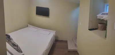 a small bedroom with a white bed in a room at KOKO House in Varna City