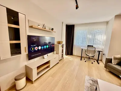a living room with a large flat screen tv at Beach Please Apartment in Burgas City