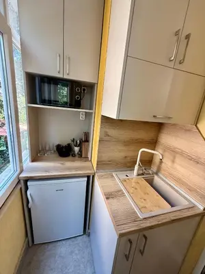 a small kitchen with a sink and a counter at Beach Please Apartment in Burgas City