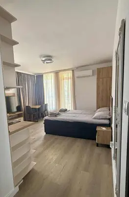 a bedroom with a bed and a living room at Апартаменти в Созопол, Каваци- Север in Sozopol