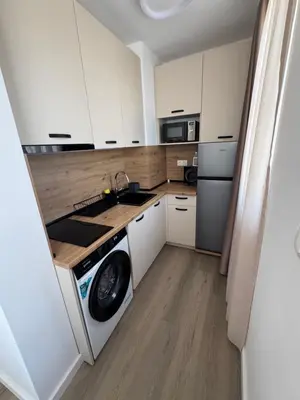 a kitchen with white cabinets and a washing machine at Апартаменти в Созопол, Каваци- Север in Sozopol