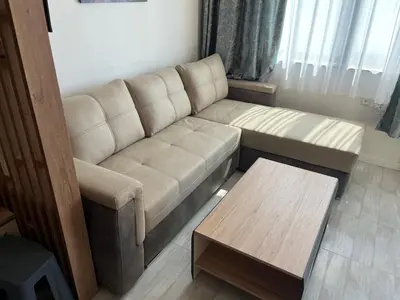 a living room with a couch and a coffee table at Onyx Sveti Vlas частни апартаменти in Sveti Vlas