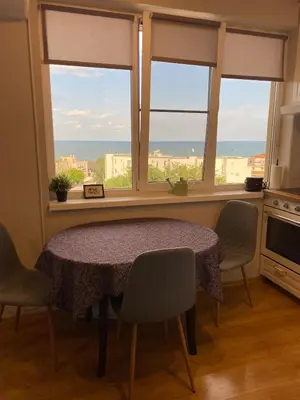 a table and chairs in a kitchen with a window at Sea View Apartment in Byala in Byala