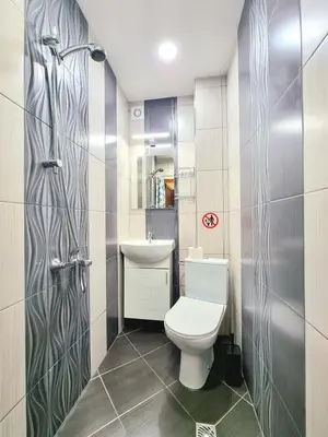 a bathroom with a toilet and a sink at Nicky's Apartment - with Private Parking in Center in Burgas City