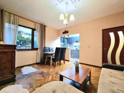 a living room with a couch and a table at Nicky's Apartment - with Private Parking in Center in Burgas City