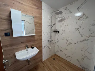 a bathroom with a sink and a mirror at Къща за гости Сирената in Sozopol