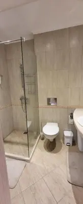 a bathroom with a shower and a toilet and a sink at Apartament Silvi Super View in Varna City