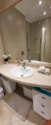a bathroom with a sink and a large mirror at Apartament Silvi Super View in Varna City