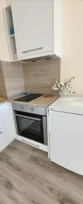 a kitchen with a stove and a counter top at Apartament Silvi Super View in Varna City