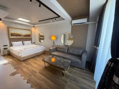 a bedroom with a bed and a couch at Studio Port Nessebar in Nesebar