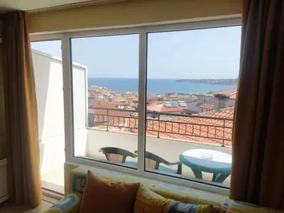 a room with a large window with a view of the ocean at Guest House Polikseni in Sozopol