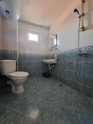 a bathroom with a toilet and a sink at Guest House Polikseni in Sozopol