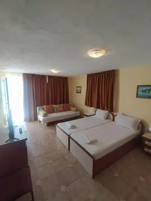 a living room with two beds and a couch at Guest House Polikseni in Sozopol