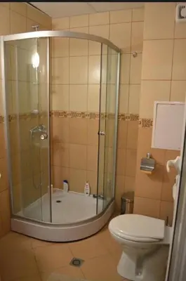 a bathroom with a shower and a toilet at Уютная студия на Солнечном берегу in Sunny Beach