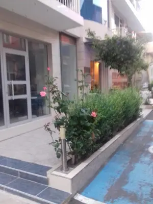 a building with pink flowers in front of a building at Alexandrov Residence Studio in Nesebar