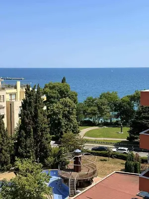 a view of a park with the ocean in the background at Panorama Vigo Studio in Nesebar