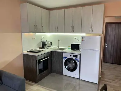a kitchen with a washing machine and a washer at Panorama Vigo Studio in Nesebar