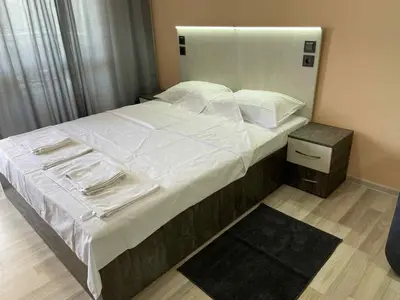 a bedroom with a large bed with white sheets and pillows at Panorama Vigo Studio in Nesebar