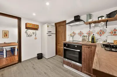 a kitchen with a stove and a refrigerator at Augusta's Authentic Farm House in Pchelnik