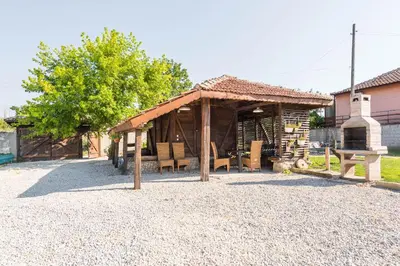 a pavilion with a table and chairs in a yard at Augusta's Authentic Farm House in Pchelnik