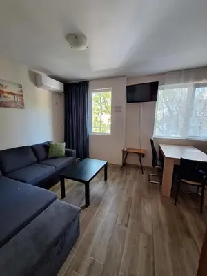 a living room with a couch and a table at Бобс апартаменти 1 in Kiten