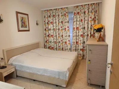 a small bedroom with a bed and a window at Royal Sun - Vaio - 1BR Apt with Balcony in Sunny Beach