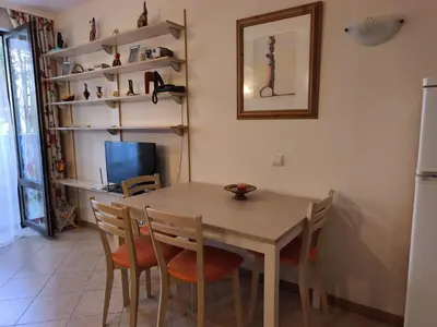 a dining room with a wooden table and chairs at Royal Sun - Vaio - 1BR Apt with Balcony in Sunny Beach