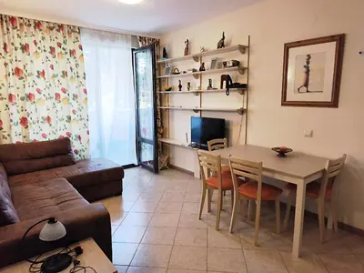 a living room with a table and a couch at Royal Sun - Vaio - 1BR Apt with Balcony in Sunny Beach