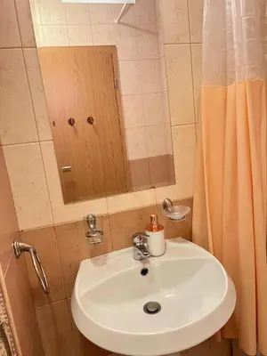 a bathroom with a white sink and a mirror at Royal Sun - Vaio - 1BR Apt with Balcony in Sunny Beach