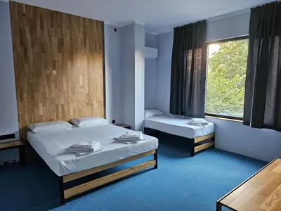 a room with two beds and a window at O'clock bed & SPA in Burgas City