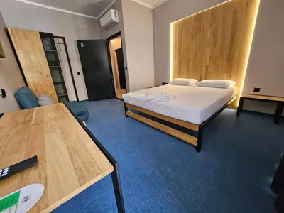 a bedroom with a bed and a desk in it at O'clock bed & SPA in Burgas City