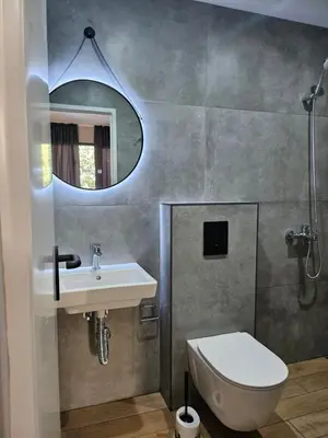 a bathroom with a sink and a toilet and a mirror at O'clock bed & SPA in Burgas City