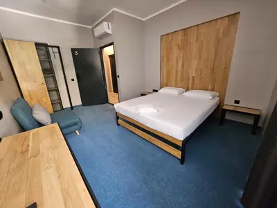 a bedroom with a bed and a chair in it at O'clock bed & SPA in Burgas City