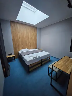 a bedroom with a large bed and a skylight at O'clock bed & SPA in Burgas City
