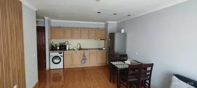 a kitchen with a washer and dryer and a table at Свети Влас Етъра1 in Sveti Vlas