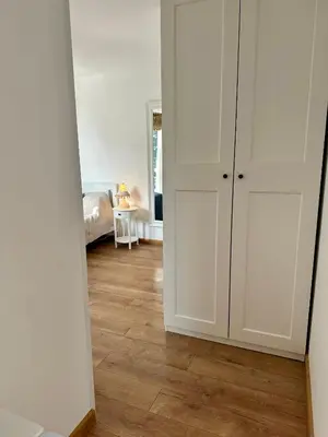 a room with white cabinets and a wooden floor at Гнездото l The Nest in Burgas City