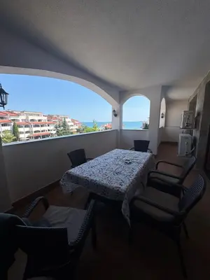 a room with a table and chairs and a large window at Каса Реал апартамент с 2 спальнями in Sveti Vlas