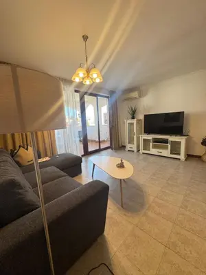 a living room with a couch and a table at Каса Реал апартамент с 2 спальнями in Sveti Vlas