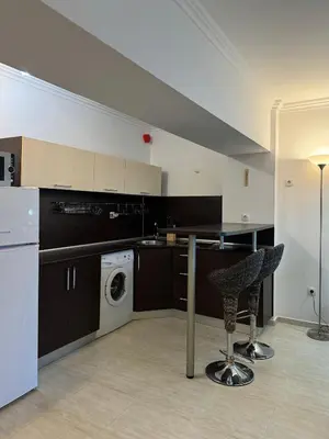 a kitchen with a washing machine and a washer at Arena Apart in Sveti Vlas