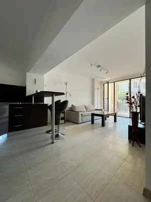 a living room with a table and a couch at Arena Apart in Sveti Vlas