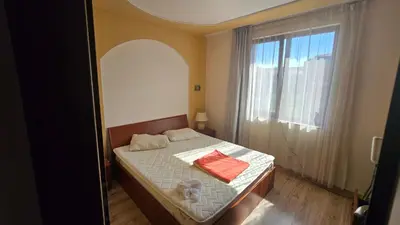 a bedroom with a bed with two towels on it at Green Life Sozopol 80m2 in Sozopol