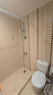 a white bathroom with a toilet and a shower at Green Life Sozopol 80m2 in Sozopol