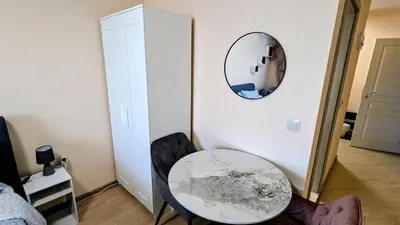 a table and chairs in a room with a mirror at Elegant studio - 100 m from Smokinya Beach by Flat Mаnager in Sozopol