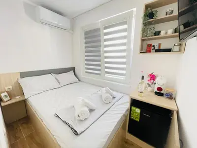 a small bedroom with a bed with towels on it at The Secret Tale in Varna City