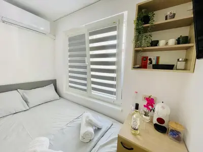 a bedroom with a white bed and a window at The Secret Tale in Varna City