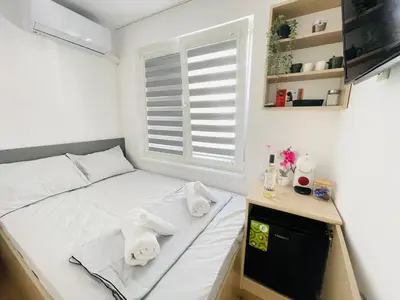 a small bedroom with a bed with towels on it at The Secret Tale in Varna City