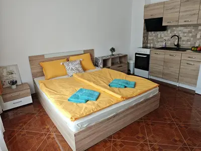 a bedroom with a large bed with two towels on it at SUN LIGHT Slnečné pobrežie in Sunny Beach
