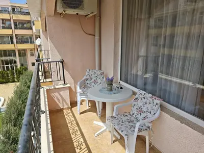 a balcony with a table and chairs on a balcony at SUN LIGHT Slnečné pobrežie in Sunny Beach