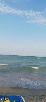 a surfboard sitting on the beach near the ocean at SUN LIGHT Slnečné pobrežie in Sunny Beach